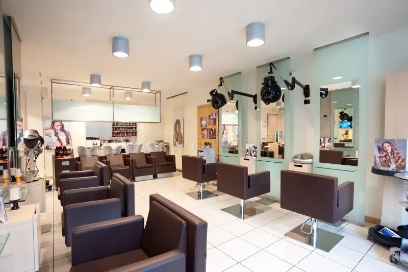 Empty salon with multiple unoccupied chairs before Stylo
